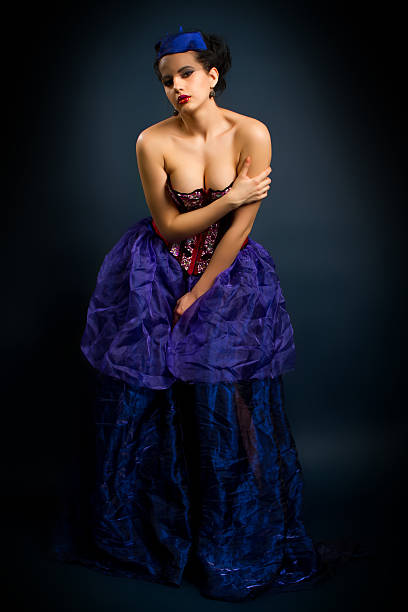 istock girl in a red corset on a dark background 509706739