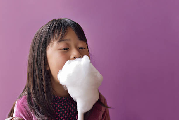 istock Asian playing with cotton candy and pretending senior 509713282