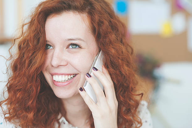 istock Red hair woman using smart phone 509720618