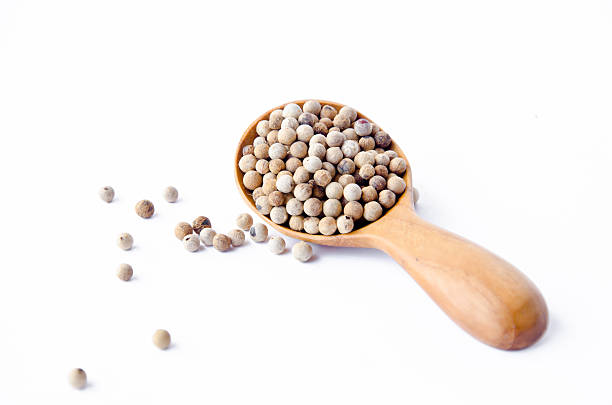 istock Allspice peppercorns in wooden spoon 509721479