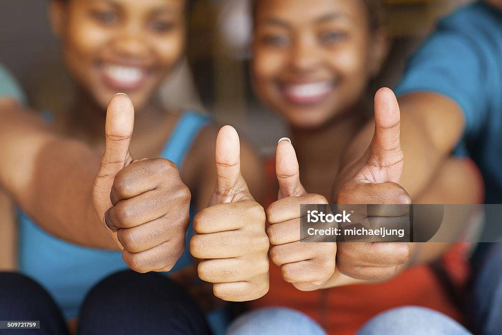 group of african friends thumbs up group of african friends thumbs up closeup Adult Stock Photo