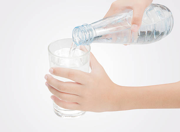 istock Drinking water is poured from a bottle into a glass 509722118