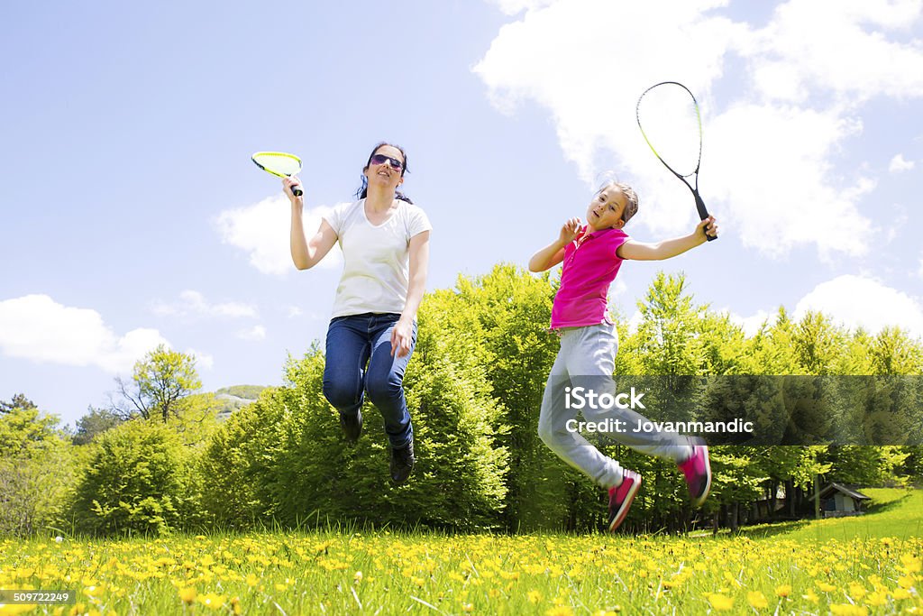 Mother and daughter playing badminton Badminton - Sport Stock Photo