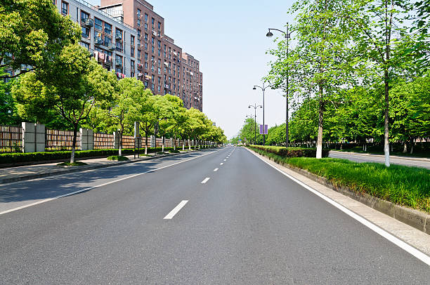 istock quiet city suburbs road 509722943