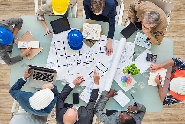 Architects and Engineers Planning on a New Project Architects and Engineers Planning on a New Project public architect stock pictures, royalty-free photos & images