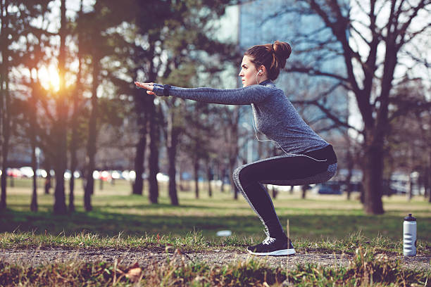 Women exercise at city park at winter