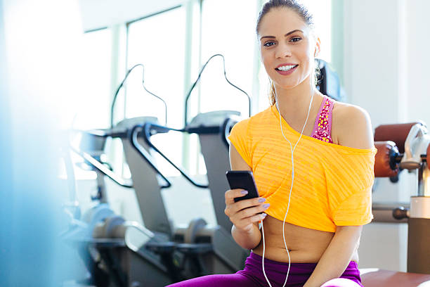 istock Woman with smart phone in gym. 509723383