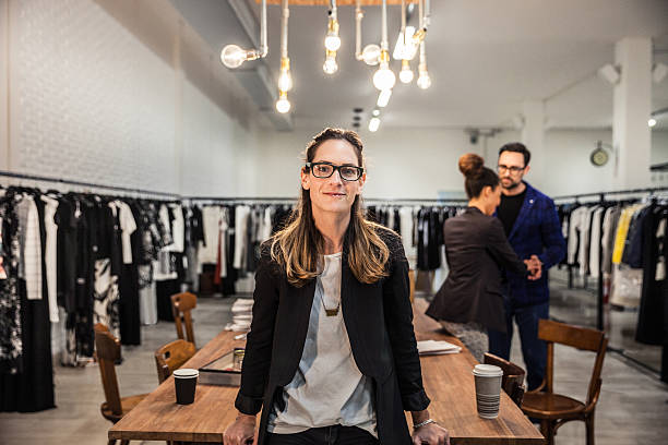 New Business employee of a clothing store New Business clothing store, owner and team. Three people team working on new arrivals in the warehouse. clothing design studio stock pictures, royalty-free photos & images