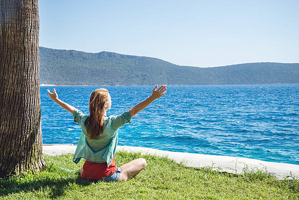 istock Woman sitting at the beach 509723499