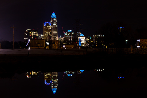 The reflection of the Charlotte skyline at night taken from the NODA area just north of uptown.