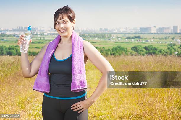 Fitness Plus Size Woman With Towel And Water Bottle Stock Photo - Download Image Now