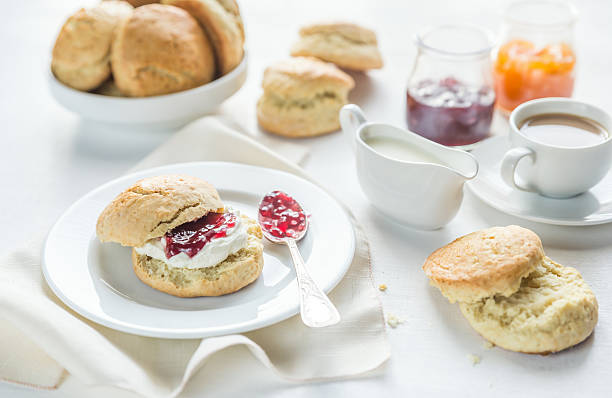 istock Scones with cream and fruit jam and cup of coffee 509724512