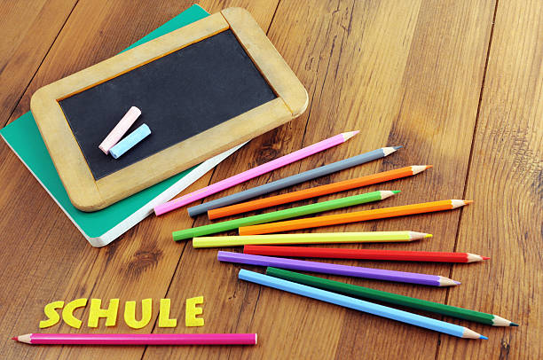 back to school chalk blackboard with german word schule (school). crayon laying aside zuckertüte stock pictures, royalty-free photos & images