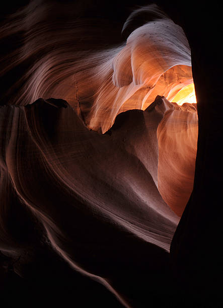 Colorful Light in Lower Antelope Canyon. Rock texture with pink, magenta and orange colors. Rock formation, game of lights. Light showing off the glamorous detail of the ancient spiral rock arches.