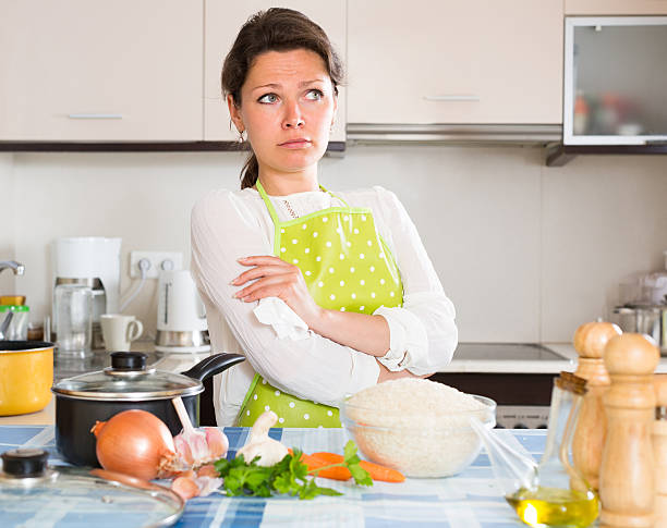 istock Sad woman cooking rice in the kitchen 509725434