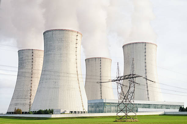 istock Nuclear power station with four steaming cooling towers. 509725558