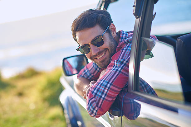 istock Young man enjoying vacation road trip with smile 509725716