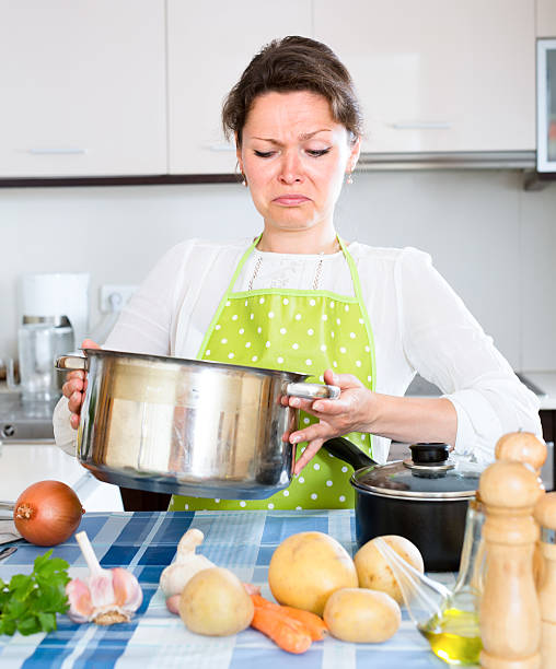 istock Woman looking at spoiled food in kitchen 509725738