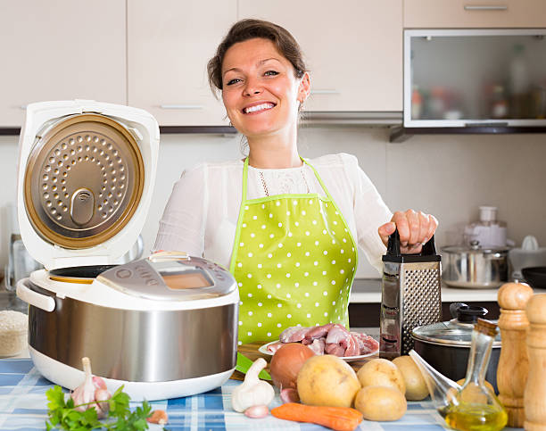istock Housewife cooking with multicooker 509725834