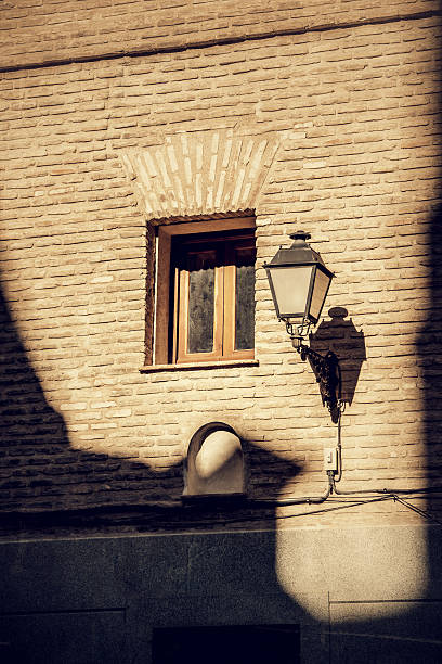 Lamp on a wall of old building, Spain