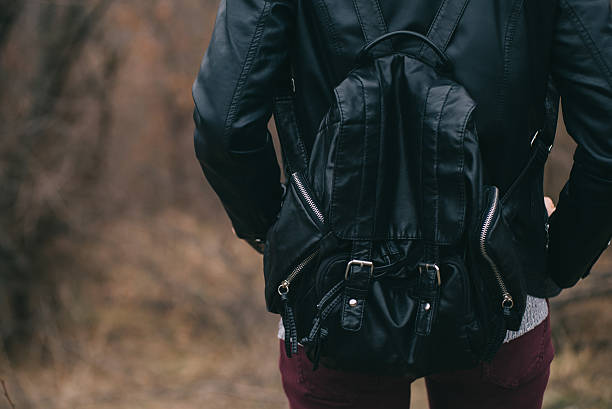 istock Girl wearing black leather jacket and backpack 509726346