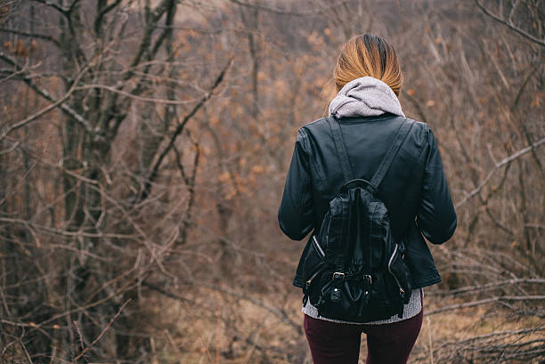 istock Girl wearing black leather jacket and backpack 509726796