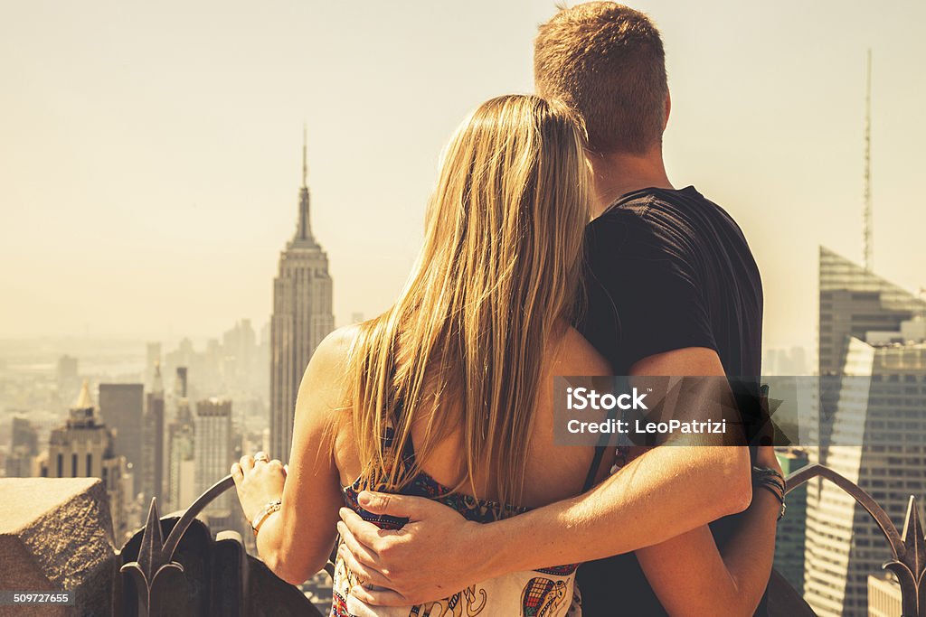Young couple in visit to New York Young couple in visit to New York posing on the top of a building. New York City Stock Photo