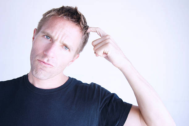 istock Young Man Scratching His Head in Confusion 509727741