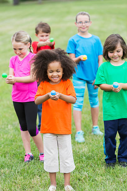 Multiracial group of children in an egg spoon race