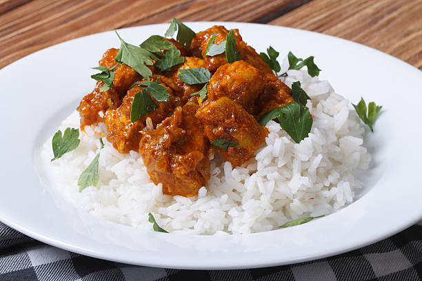 istock Chicken curry with rice and cilantro on white plate 509728419