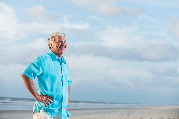 istock Happy senior man on beach, hands on hips 509728586