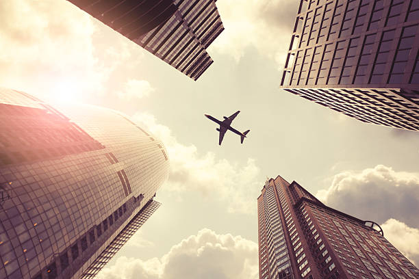 istock Airplane flying above skyscrapers 509729654