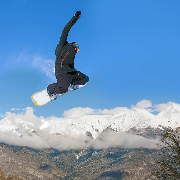 istock Snowboarder doing high jump above the mountain 509729792