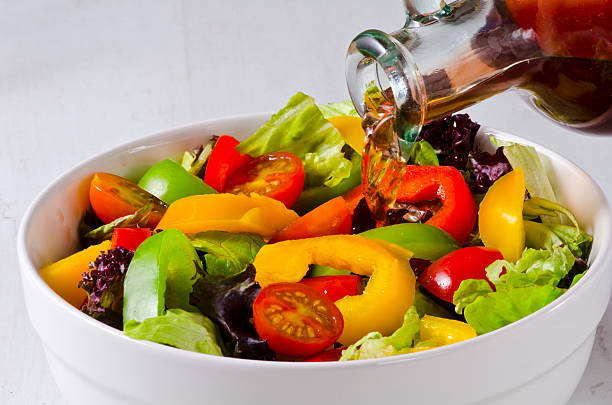 istock Vinegar pouring into salad bowl 509733262