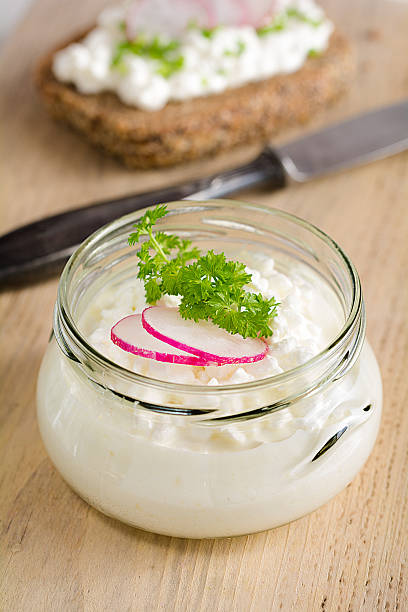 istock A glass filled with grainy cream cheese 509733546
