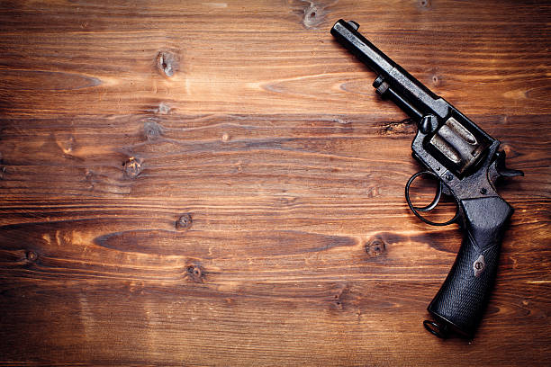 istock Old gun on wooden background 509733982