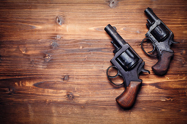 istock Old gun on wooden background 509734064