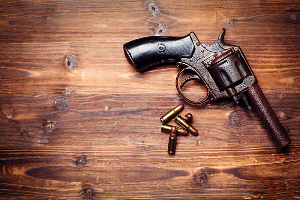 istock Old gun on wooden background 509734524