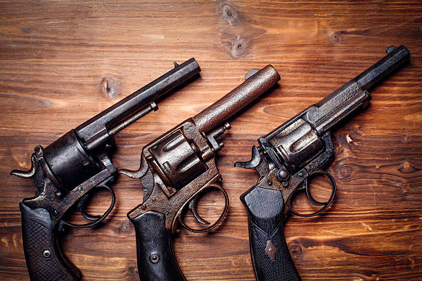istock Old gun on wooden background 509734728