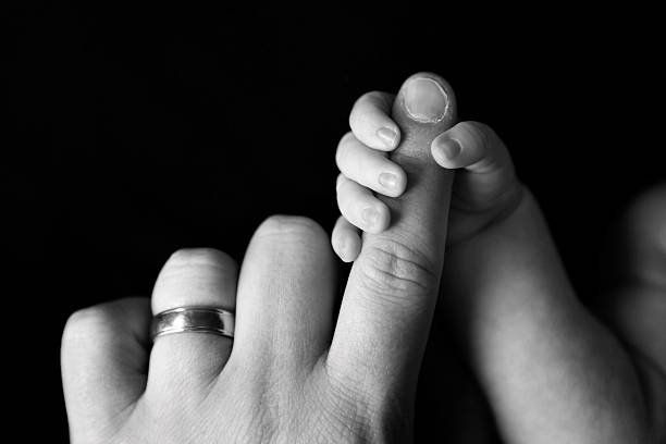 istock Newborn Gripping Dad's Finger 509734816