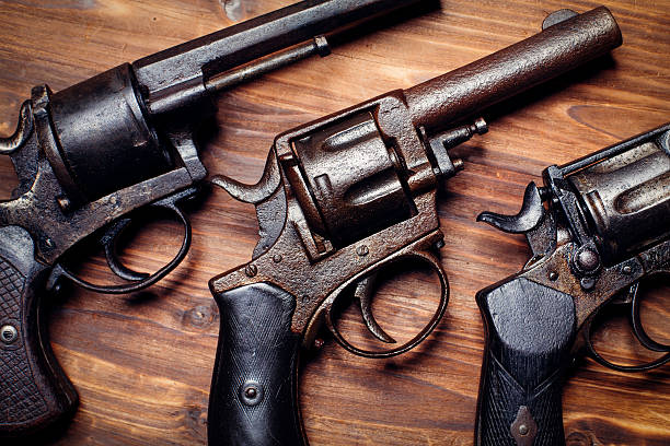 istock Old gun on wooden background 509734818