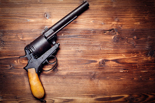 istock Old gun on wooden background 509735100
