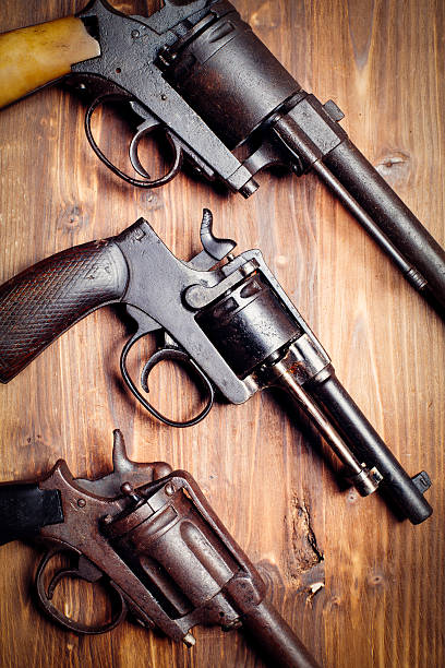 istock Old gun on wooden background 509735170