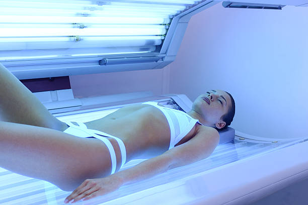 istock Attractive woman tanning at solarium 509736998