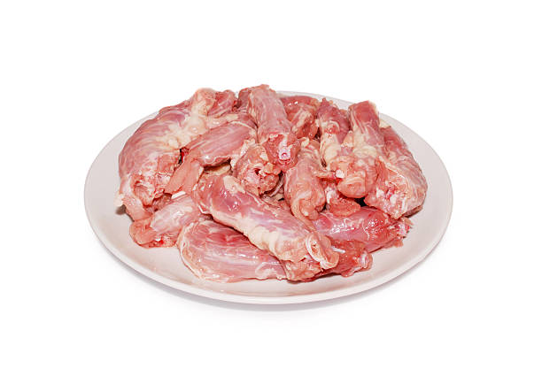istock Chicken offal. Raw  necks on a dish against white background 509739416