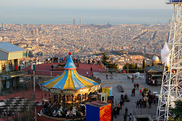 Barcelona, Spain - December 28, 2015: Tibidabo amusement park, with people having fun in the top of the city of Barcelona, Spain, on December 28, 2015