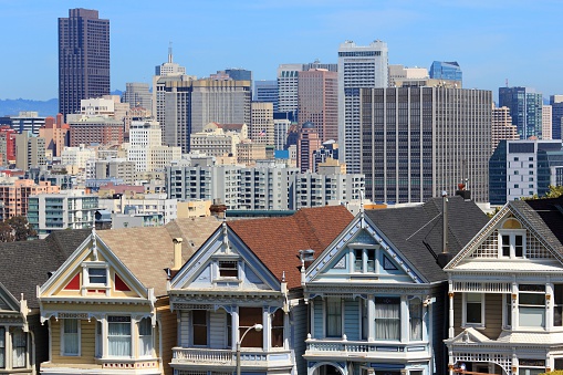 San Francisco, California, United States - city skyline with famous Painted Ladies, Victorian homes at Alamo Square (Western Addition neighborhood).