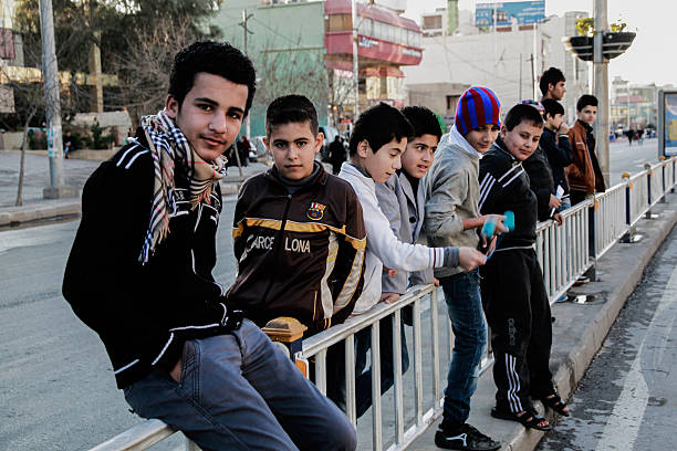Sulaimania, Iraq – December, 31 2012 : Children in Sulaimania, Kurdistan Iraq waiting along Salim Street  for New Year Celebrations.