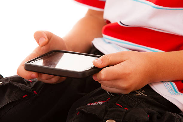 istock Little boy playing games on smartphone 509757467