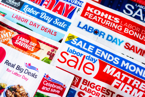 Colorado Springs, Colorado - August 31, 2014: A horizontal studio shot of a collection of 2014 American newspaper inserts promoting various Labor Day sales.